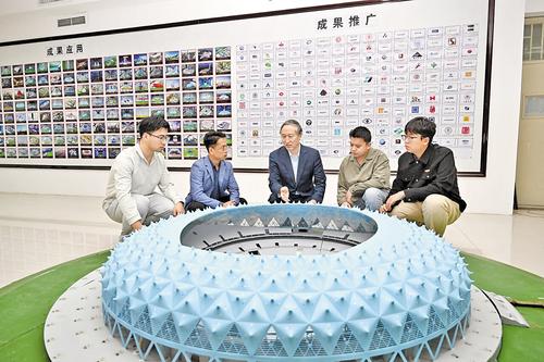 10月17日，刘庆宽（左三）和学生对体育场大跨度结构风荷载和风环境进行研究。 本报记者 史晟全摄